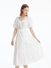 a lady in white puff sleeve dress